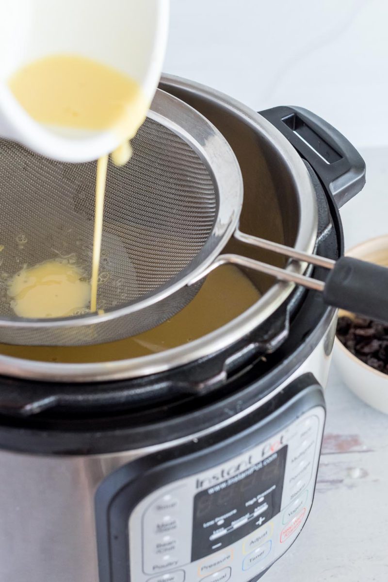 Adding the egg to the cooked rice pudding in the Instant Pot to thicken and create the creamy texture.