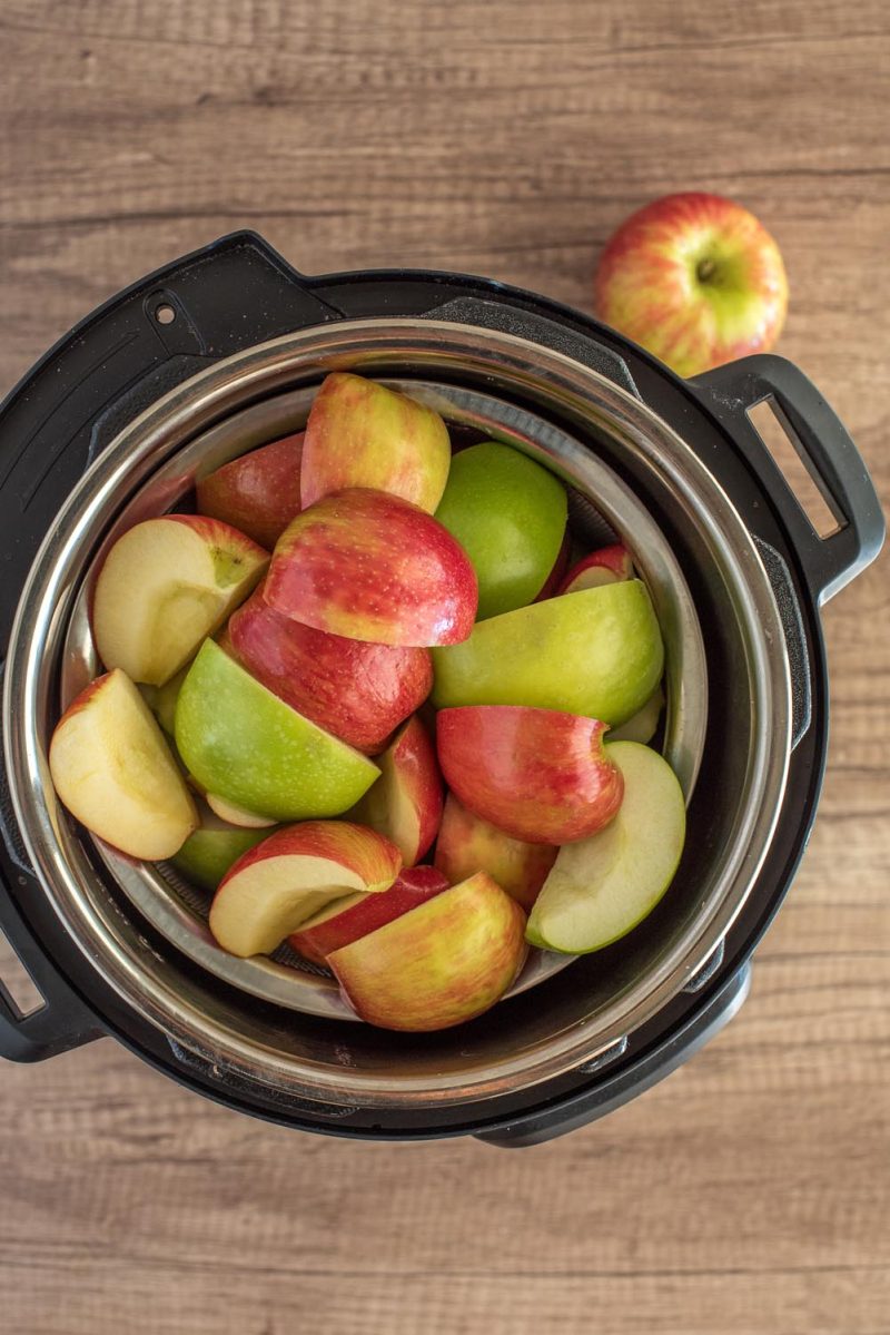Overhead picture of quartered apples in an Instant Pot to make apple butter.