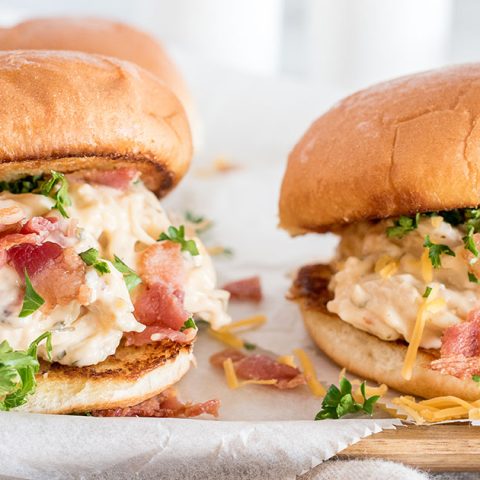 Tight, close-up shot of two crack chicken ranch sandwiches with bacon, made in an Instant Pot, ready to serve.