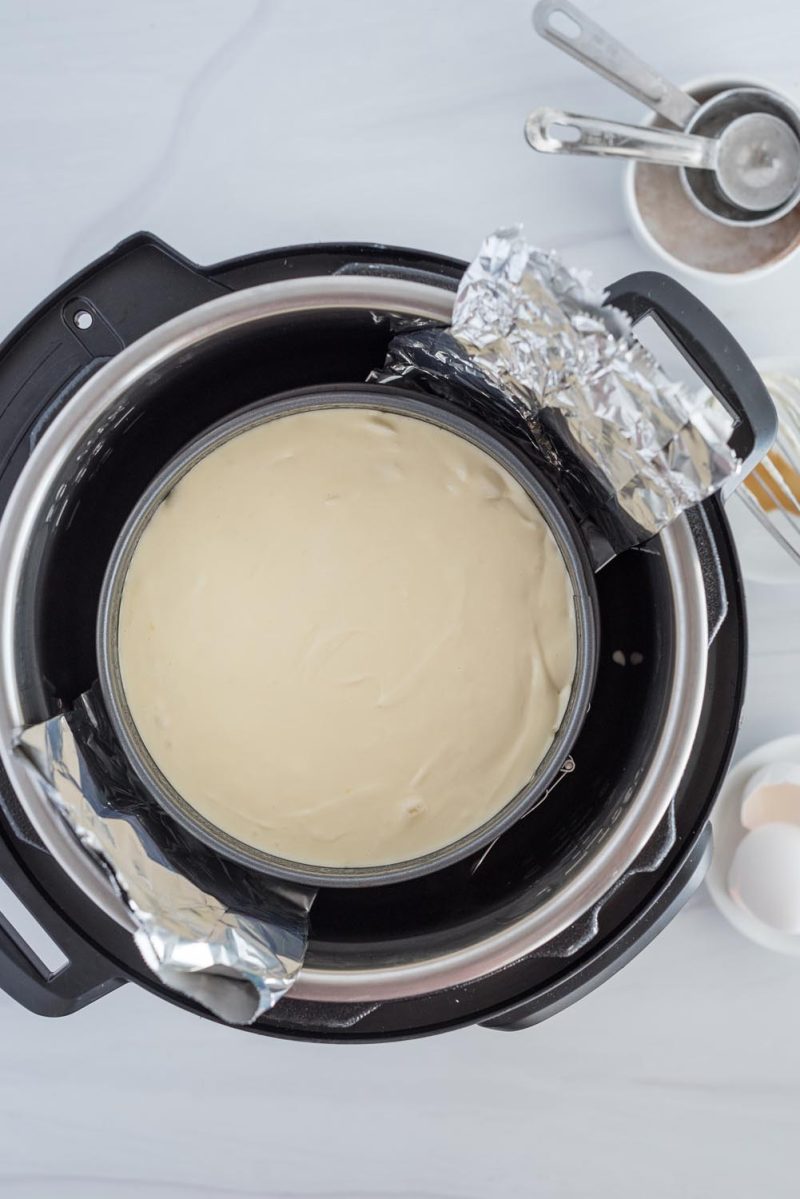 An overhead picture of a cheesecake ready to bake inside an Instant Pot for Black Forest cheesecake.
