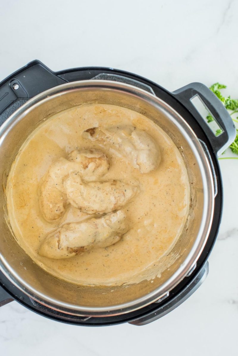 Chicken lazone cooked and in a cream sauce inside an Instant Pot.