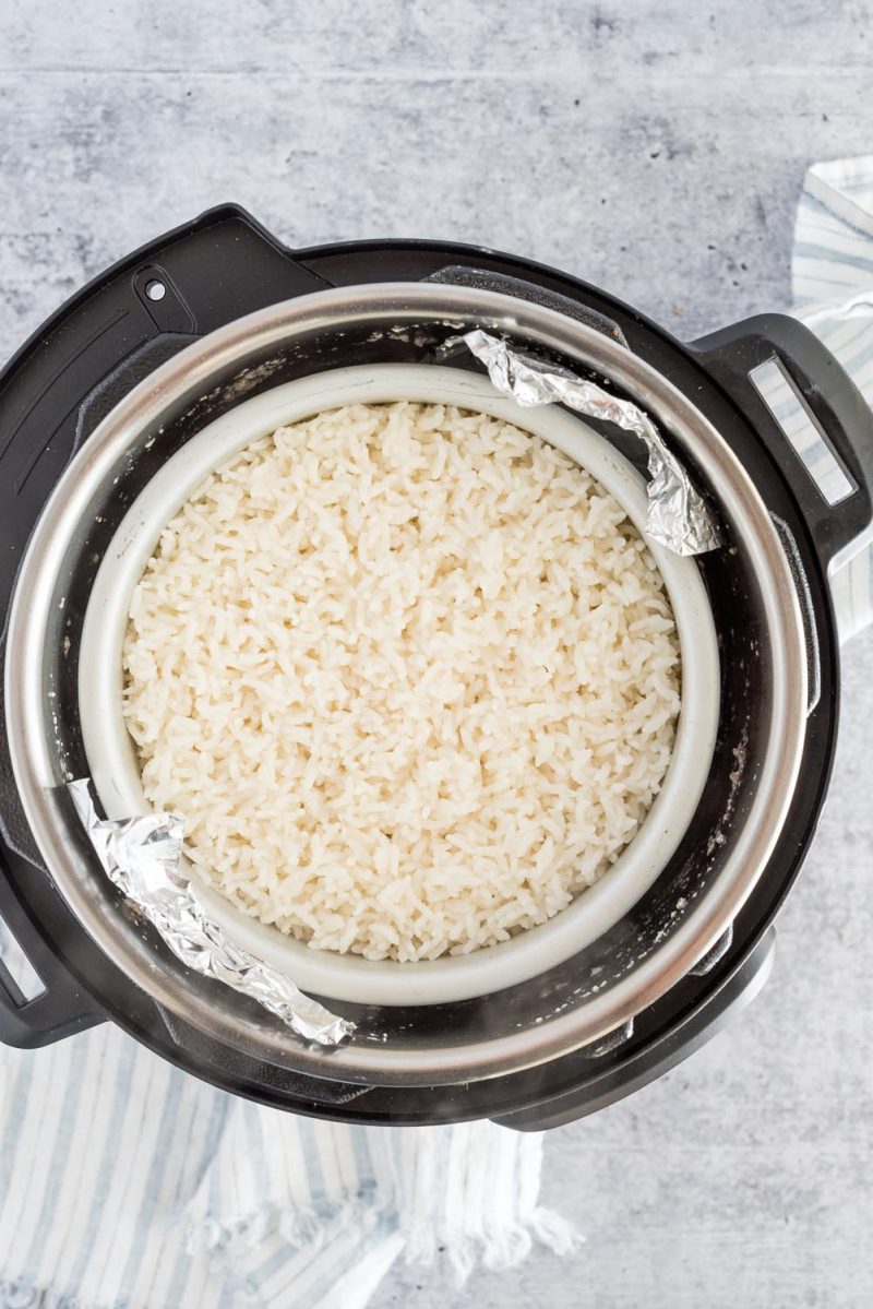 Cooking rice in an Instant Pot using the pot in pot method so it can cook in a cake pan over the chicken while it cooks.