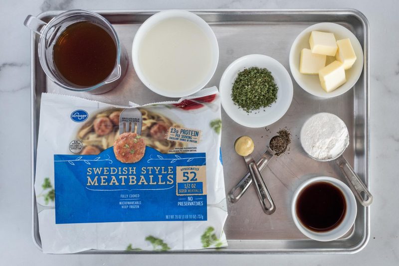 Ingredients for making Instant Pot Swedish Meatballs, including, frozen meatballs, beef broth, mustard, pepper, flour, butter, and parsley.