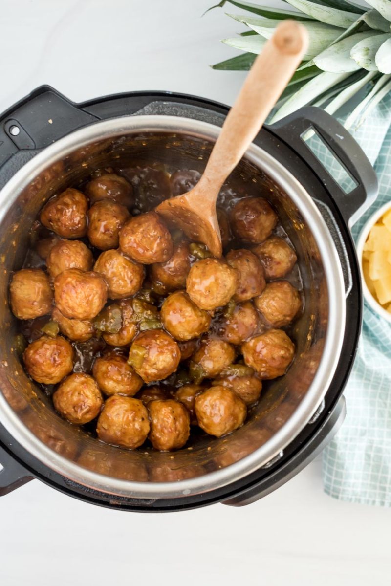 An overhead picture cooking Hawaiian meatballs in an Instant Pot.