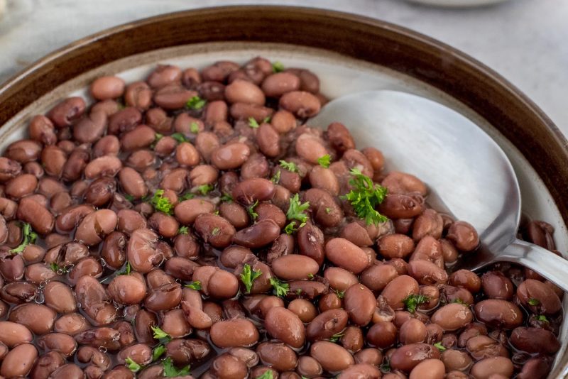 Close up picture of a bowl of Instant Pot kidney beans, topped with fresh parsley