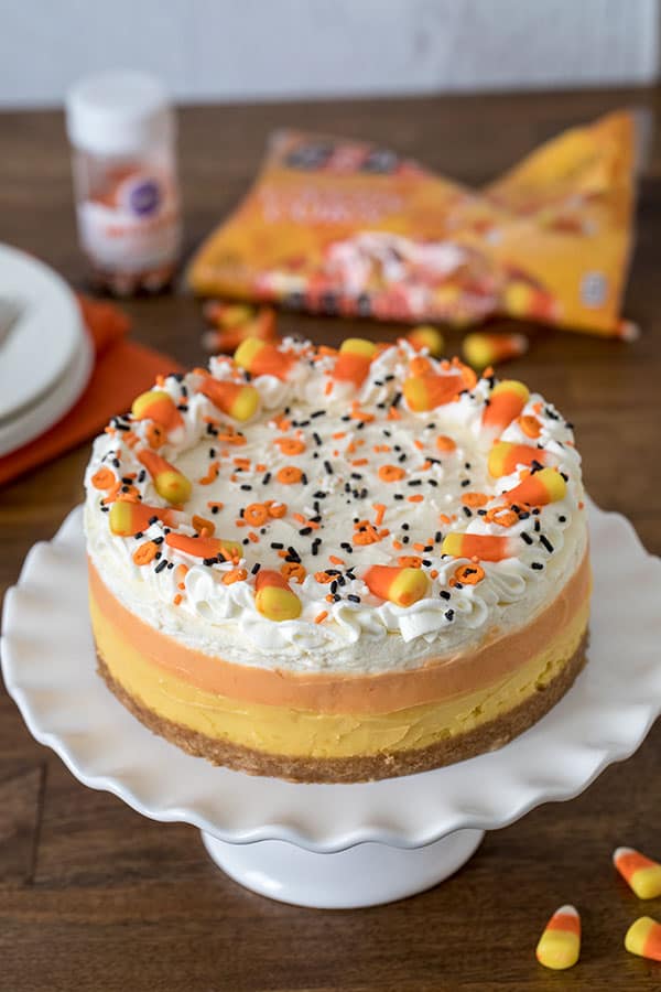 Decorating a luscious, easy-to-make Pressure Cooker Candy Corn Cheesecake sweetened with honey. 