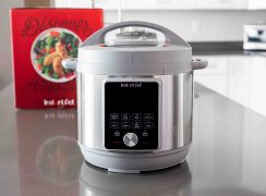 The Instant Pot Duo Plus Whisper Quiet on a kitchen counter with the box in the background.