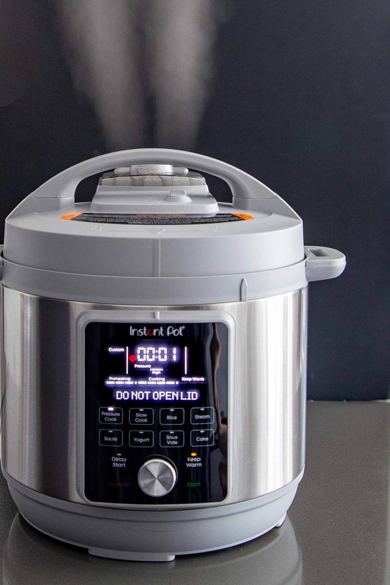 The Instant Pot Duo Plus Whisper Quiet releasing steam through the steam release cover.
