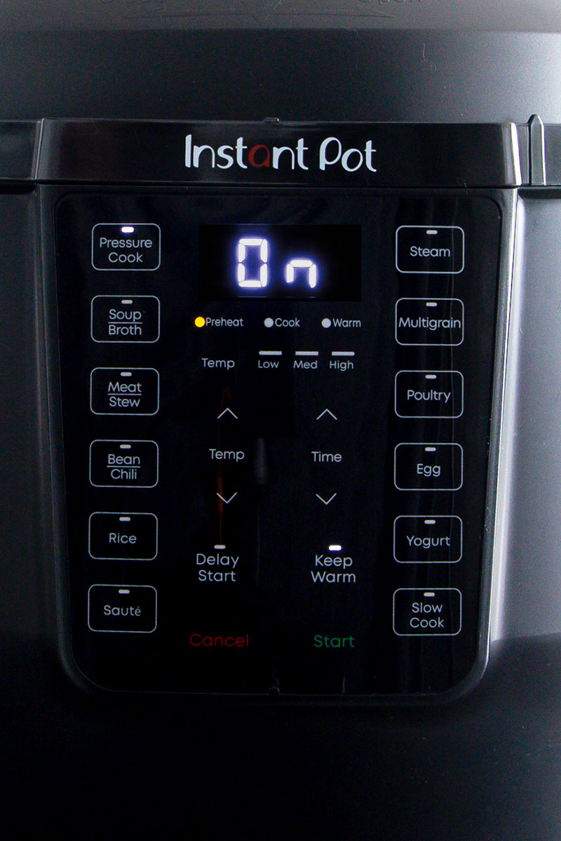 A close up picture of the buttons and display of the Instant Pot Rio, buttons include pressure cooke, soup/broth, meat/stew, bean/chili, rice, sauce, steam, multigrain, poultry, egg, yogurt, and slow cook.