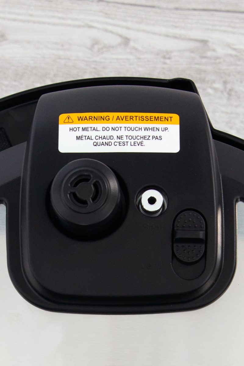 A close up picture of the steam release button and float valve on the Instant Pot Rio.
