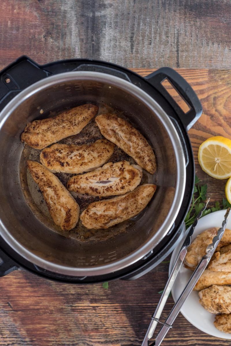 Browning the chicken tenderloins in an Instant Pot for lemon chicken piccata.