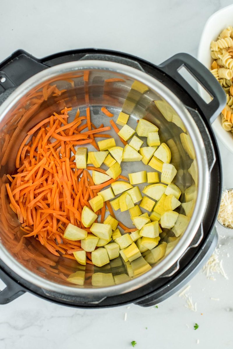 Match stick carrots and yellow squash in the bottom of an Instant Pot to be covered by just cooked noodles for pasta salad.