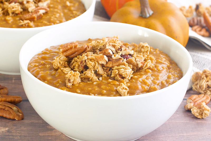 Pumpkin Spice Instant Pot Steel Cut Oats in a white bowl, topped with pecans and granola
