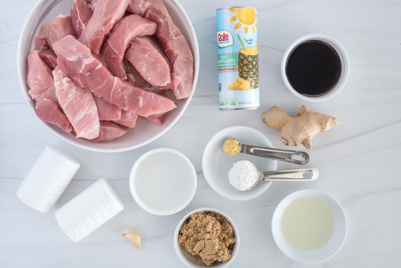 Ingredients for Instant Pot sweet and sour country style ribs, including, country style ribs, ginger, soy sauce, pineapple juice, vinegar, and spices.
